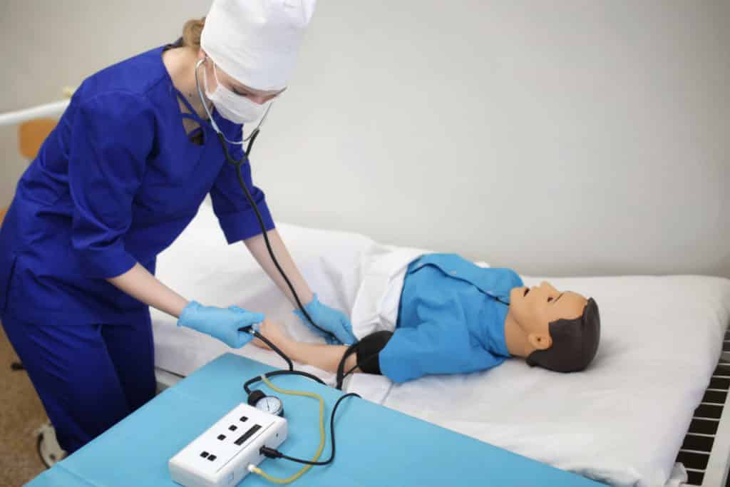 medical student measures the pressure on the dummy. Training in medical practice in the training hospital