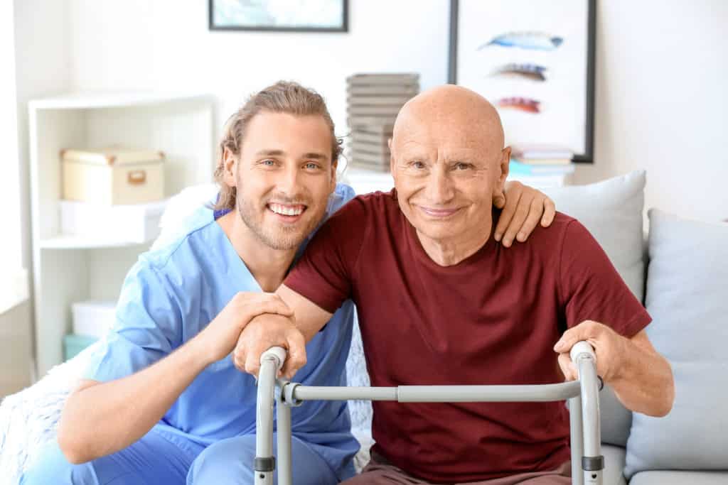 Elderly man with caregiver in nursing home